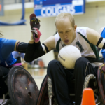 3 rugby wheelchair players fighting for the ball