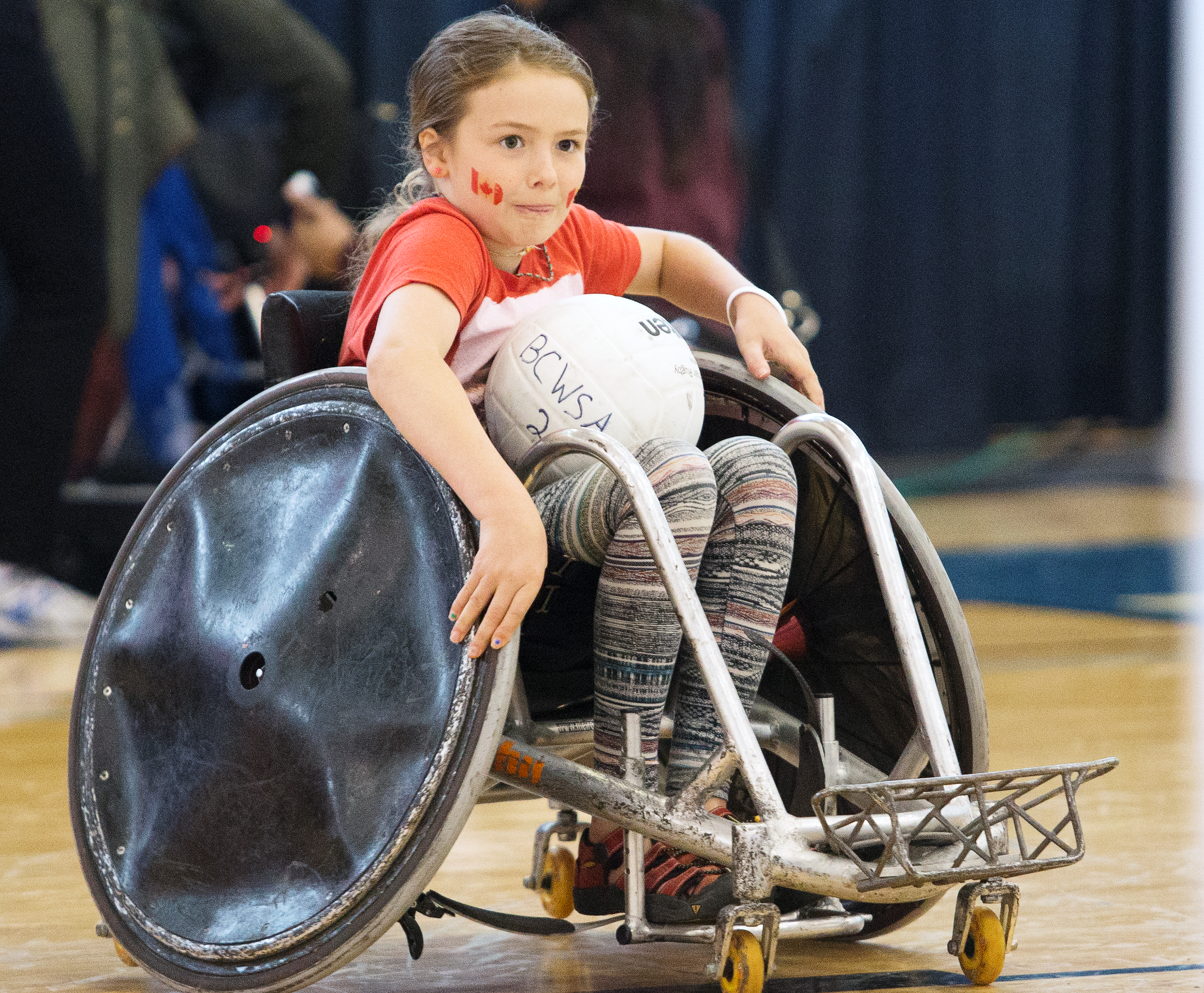 young happy and smiling girl playing wheelchair rugby
