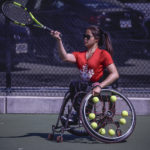 wheelchair tennis player hitting a volley