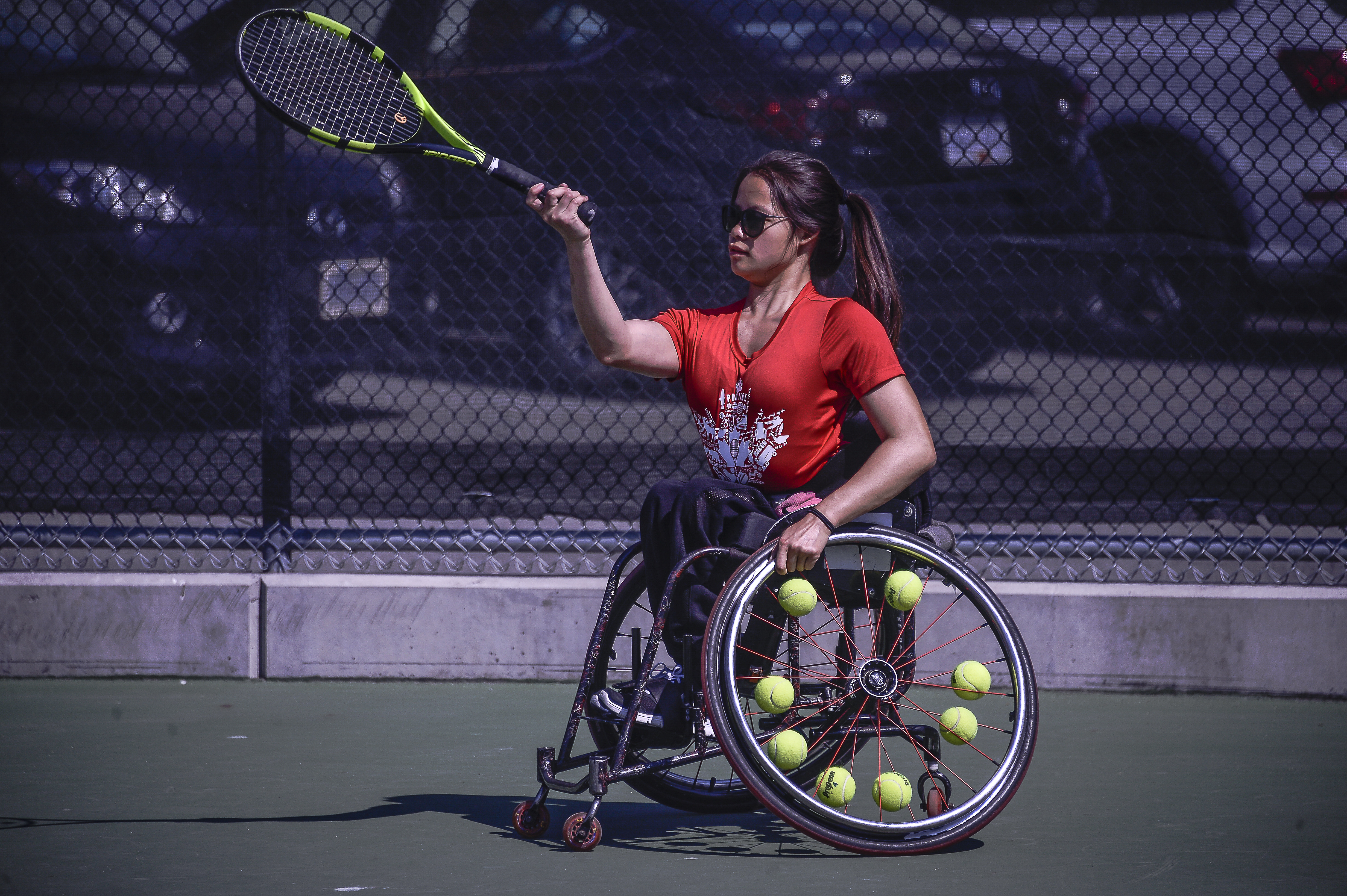wheelchair tennis player hitting a volley